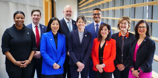 Photo of 2024 Seattle City Council members posing and smiling outside of Council Chambers