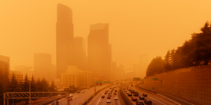 View of a highway in the city in which the sky is orange and smoggy