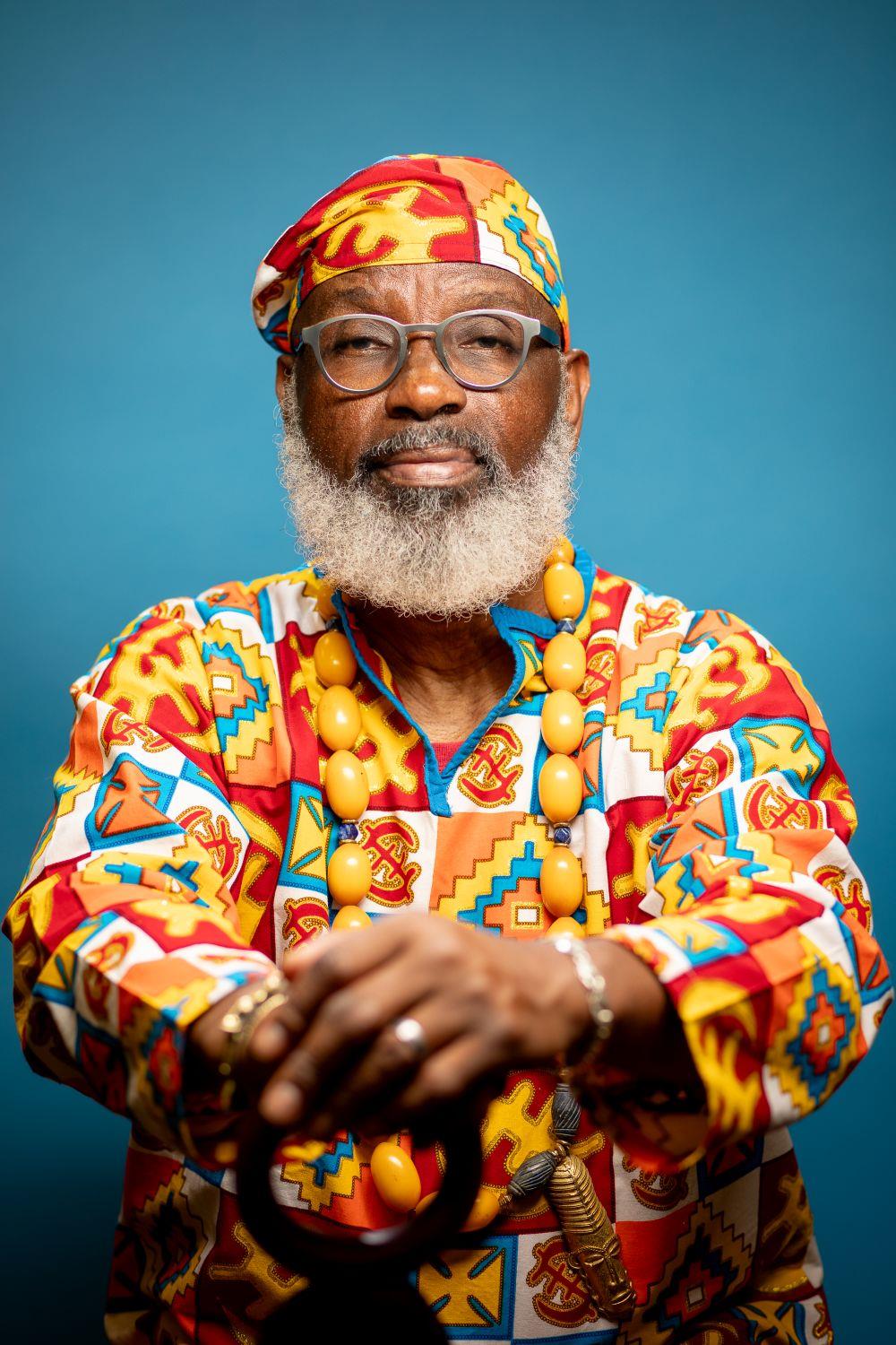 An elder Black man wearing colorful clothing