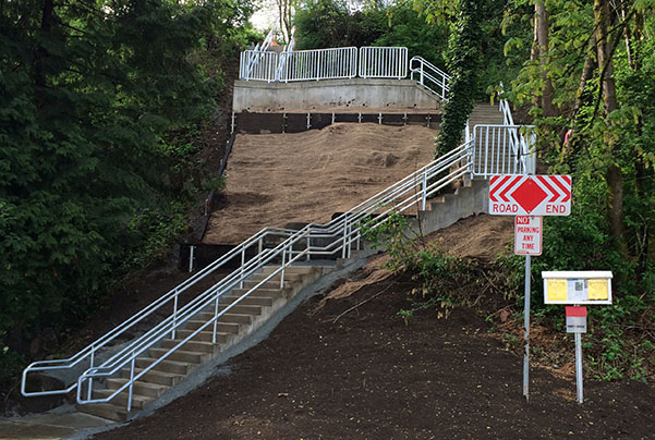 A finished stairway with flyers posted at the bottom