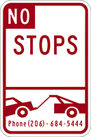 Sign No Stops and a car being towed