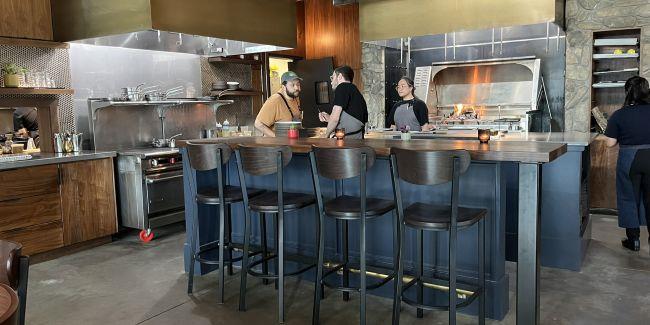 ኩሽና ውስጥ ጥቂት ሰራተኞች ጋር ያሉበት የታደሰ ምግብ ቤት  