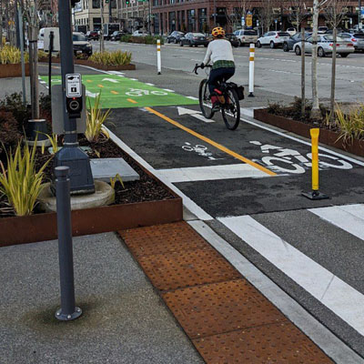 Bike path and intersection showing marking and tactile surfaces.