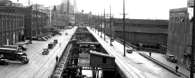 Black and white photo of the Seattle Waterfront during first seawall construction around 1911.