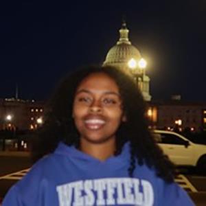 Koreb smiling at night with the capital building in the background