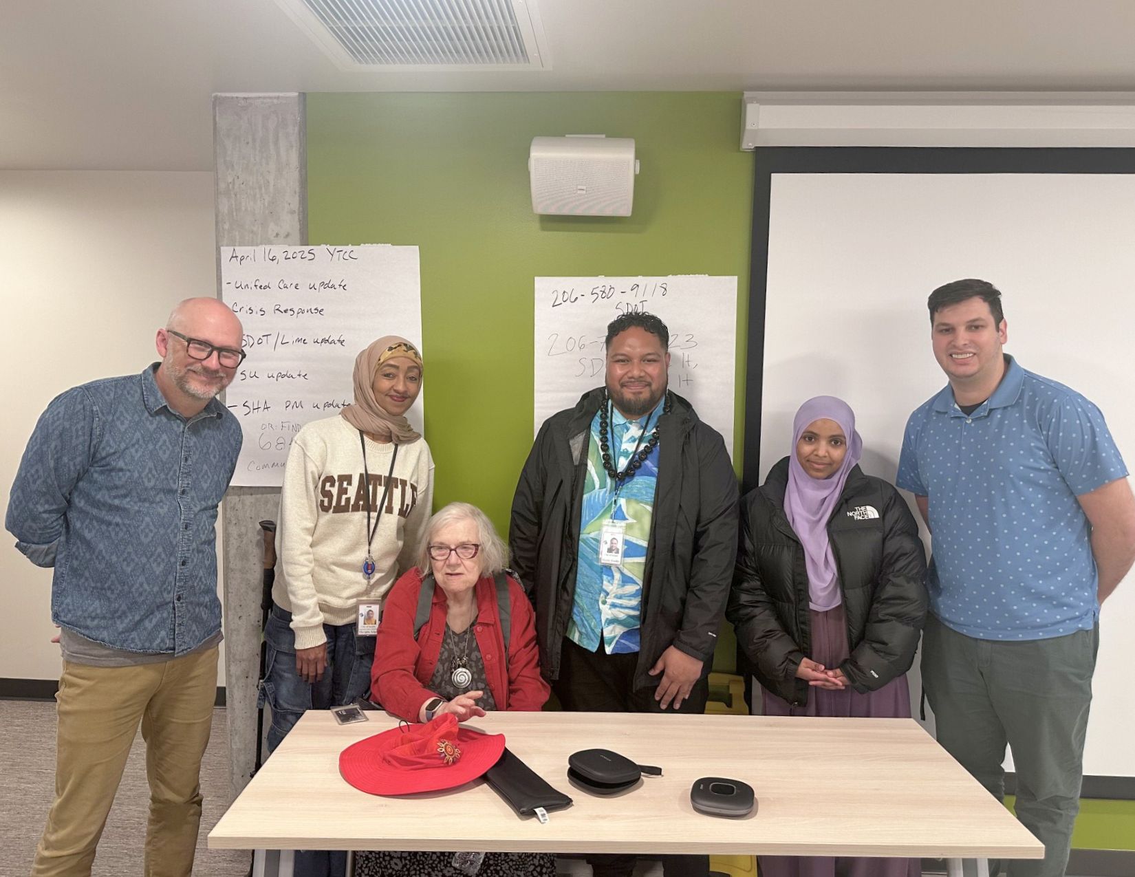 CPC's Mergitu Argo, Mario Teulilo, and Kieryn High with members of the Yesler Terrace Community Council.