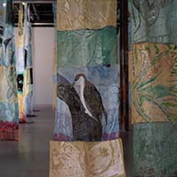 View of "The 1 Million - Multiple Species Eradication by Carol Rashawnna Williams" exhibit at ARTS at King Street Station, with a focus on a painting of penguins