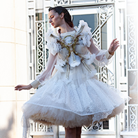 Model Sage Bell wearing a white tulle dress with a kinetic garment chest piece.