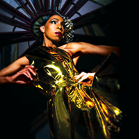 Model Adé Cônnére wearing gold thermoplastic polyurethane dress.
