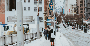 Pedestrians walking on snow covered downtown Seattle street