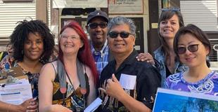 Group of people smiling in the sun