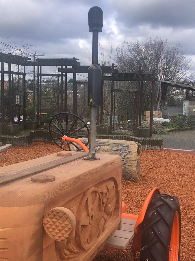 Bradner Gardens Park planting beds and tractor sculpture