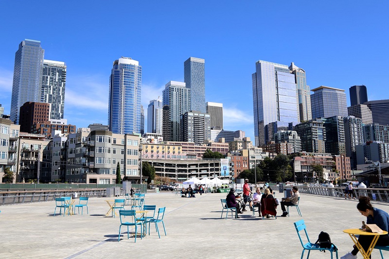 people sitting on the new Pier 62 looking toward Elliott Bay 
