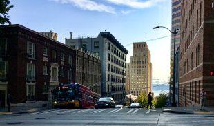 Cars, pedestrians, and a bus on a street in downtown Seattle