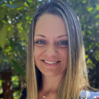 Photo of Candace Goodrich, outside in front of a tree