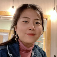 Ziqi Wang inside with a pink turtleneck sweater