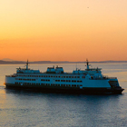 A Washington State ferry making a crossing during sunset