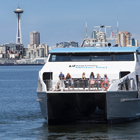 Water Taxi going to West Seattle with Seattle skyline behind it