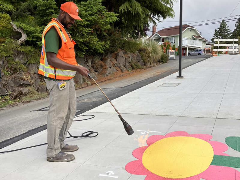 Crew installing a flower decal, designed by Vera Brown