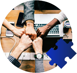 A team of hands fist bump over a keyboard