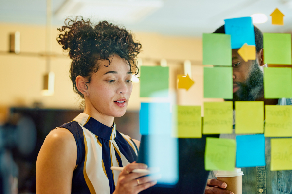 A woman working with a kanban board