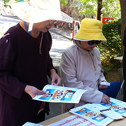 People reading emergency preparedness documents in different languages