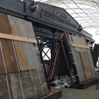 The pergola being restored, under an awning to protect it from the weather