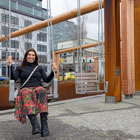 A smiling park-goer enjoys the swings near Colman Dock.